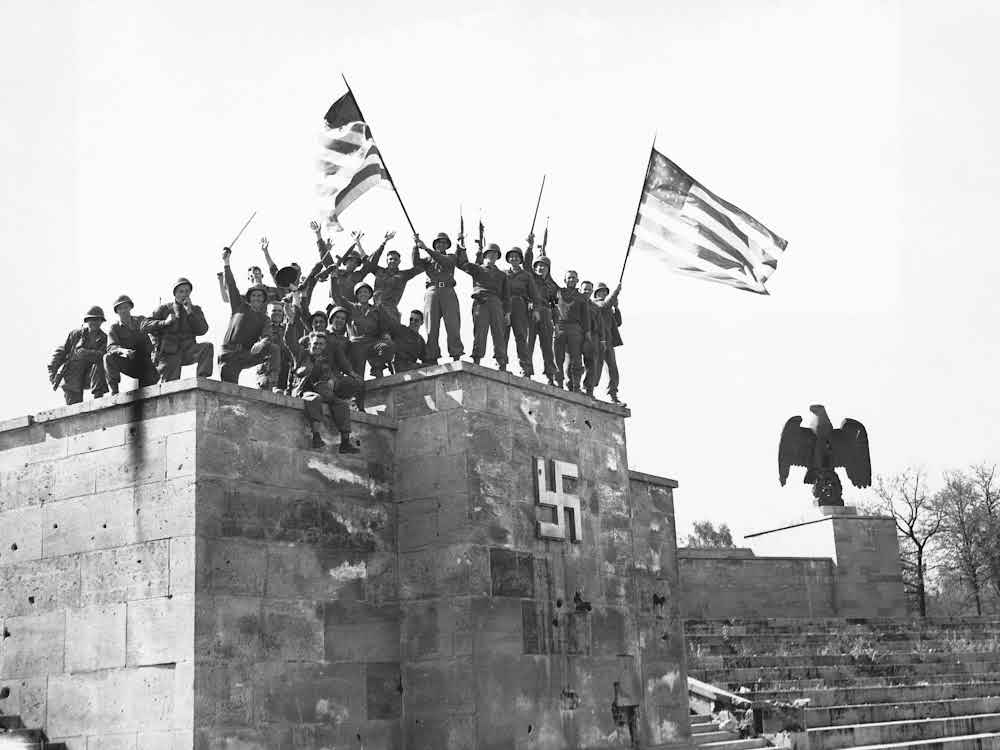 The allied forces standing in victory over the Nazi Symbol